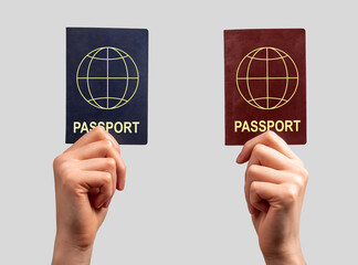 Two different passports in hands. Abstract citizenship nationality documents. Double citizen...