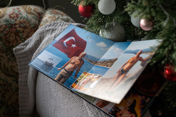 photo book about traveling near the Christmas tree