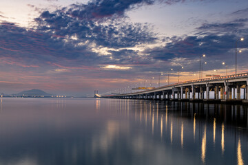 Fototapeta na wymiar Sunrise shoot under the Penang Bridge. Penang bridges are crossings over the Penang Strait in Malaysia. They connect the area of Seberang Perai on the Malay peninsula with the island of Penang.
