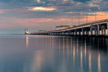 Obraz na płótnie Canvas Sunrise shoot under the Penang Bridge. Penang bridges are crossings over the Penang Strait in Malaysia. They connect the area of Seberang Perai on the Malay peninsula with the island of Penang.