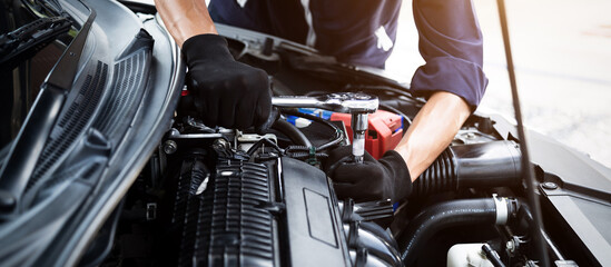 Automobile mechanic repairman hands repairing a car engine automotive workshop with a wrench, car service and maintenance , Repair service