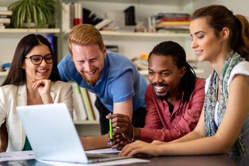 Group of business partners discussing documents and ideas at meeting in corporate office