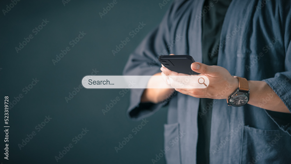 Leinwandbilder Man using a mobile phone in the room for searching browsing internet data information. Business concept for Using search with your website.