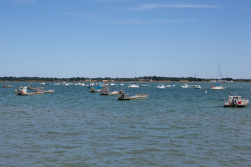 Motorized flat boats moored. Boats for work on the oyster and mussel beds are moored on a calm sea.