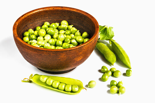 Fresh green peas in a clay cup
