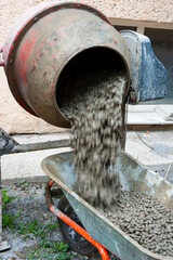 Now the finished cement mortar is unloaded into a wheelbarrow for delivery to the place of its use.