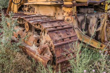 Old rusty bulldozer caterpillars in nature close-up