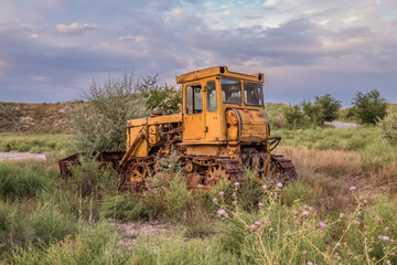 Abandoned yellow bulldozer in a quarry