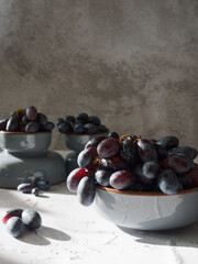 Big purple grapes on grey background