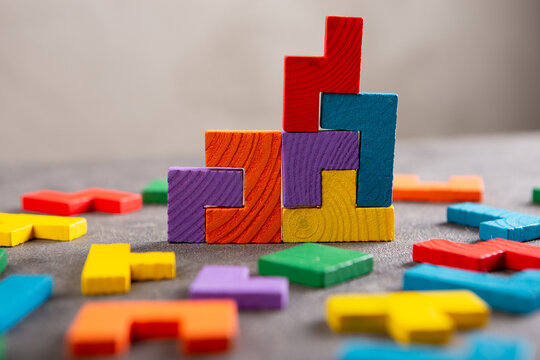 Creative idea solution - business concept, jigsaw puzzle on the grey background. Leadership and teamwork strategy success.