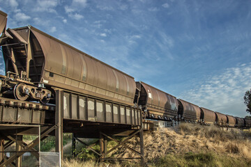 Coal trains hauling coal and crossing a bridge