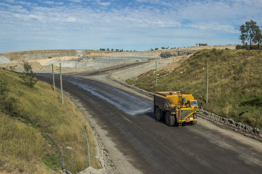 Mine truck spraying the roads with water to minimise dust