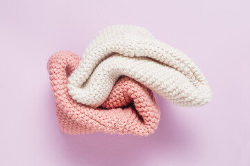 Knitted things on a purple background view from above. Stylish knitting banner