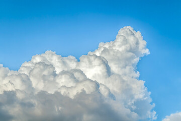Naklejka na ściany i meble Thunderclouds against the blue sky. Template for wallpaper, stretch ceilings