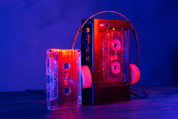 Vintage cassette tape player in neon light. 80s - 90s advertisement style. Disco party nostalgy concept