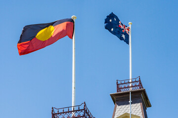 Looking up at an Australian and Aboriginal flag flying next to one another