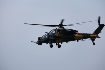 Fototapeta na wymiar Hovering Power: Commanding Presence of an Attack Helicopter in Mid-Air