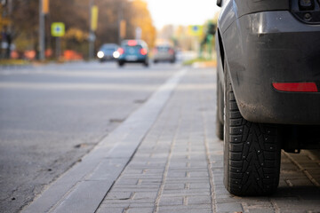 Close-up of a car with studded wheels on the roadway