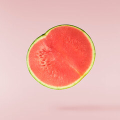 Fresh raw watermelon falling in the air isolated