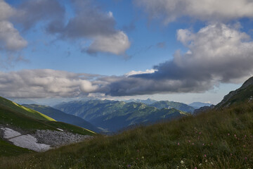 Fototapeta premium green mountains against the sky and sunset