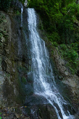 Obraz premium mountain waterfall with clean drinking water on the route in a hike in the mountains