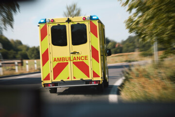 Ambulance car of emergency medical service on road in blurred motion. Themes rescue, urgency and...