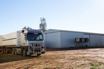 Semi trailer truck near shed on a farm