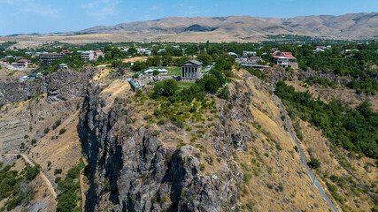 Fototapeta na wymiar panoramic view of a mountain landscape with an old Christian church against the sky in Armenia taken from a drone