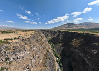 panoramic view of a mountain landscape with a gorge against the sky in Armenia taken from a drone