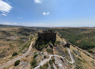 panoramic view of a mountain landscape with an old dilapidated fortress against the sky in Armenia taken from a drone