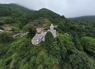 panoramic view of a mountain landscape with an old Christian church against the sky in Armenia taken from a drone