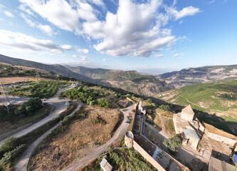 panoramic views of ancient temples and buildings in picturesque places in a gorge in the mountains of Armenia taken from a drone