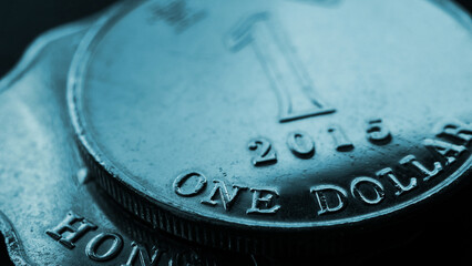 1 one Hong Kong dollar. Fragment of textured coin. Blue tinted wallpaper or background about economics or banking. Coins and money of Hong Kong. News about the exchange rate or inflation. Macro