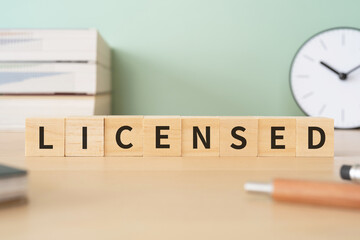 「LICENSED」と書かれたブロックが置かれたデスク
