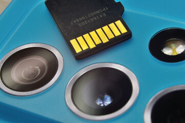 micro sd card lies on the block of smartphone cameras. close-up