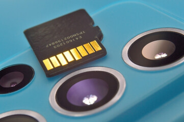 micro sd card lies on the block of smartphone cameras. close-up