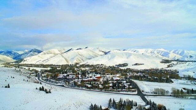 Aerial Beautiful View Of Town By Snowy Mountains, Drone Flying Forward Over Trees On Landscape - Sun Valley, Idaho