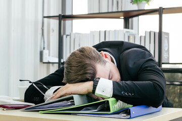 Frustrated caucasian businessman take a nap at his desk.