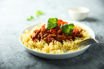Pasta with spicy meat ragout and chili