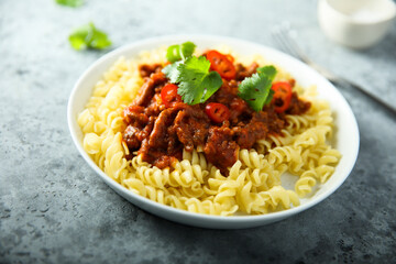 Pasta with spicy meat ragout and chili