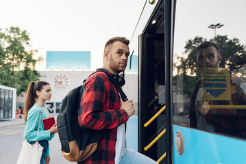 Man entering the bus while traveling in the city