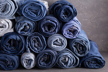 Blue jeans denim heap on table background. Jeans fabric heap as material surface