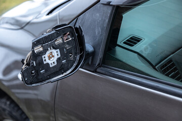 a broken rearview mirror on a passenger car