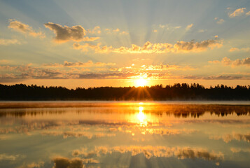 Lake, beautiful nature landscape. Sunrise on a forest lake or river, pond, panoramic view. Early morning, fog, dawn, sun is reflected in water