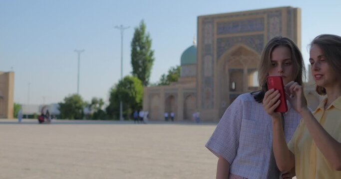 Two girls tourists enjoy the sights of Uzbekistan, Tashkent city, Khast Imam