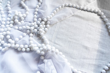 pearl necklace on white silk, background for wedding concept