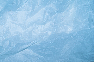 Obraz premium Texture of crumpled paper, pale blue empty background