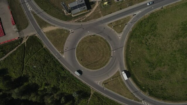 The movement of cars at a roundabout from a great height. Aerial photography.