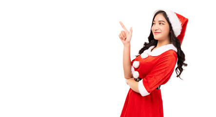 Young woman wearing red Santa Claus outfit and Santa Claus Hat pointing up to copy space isolated...