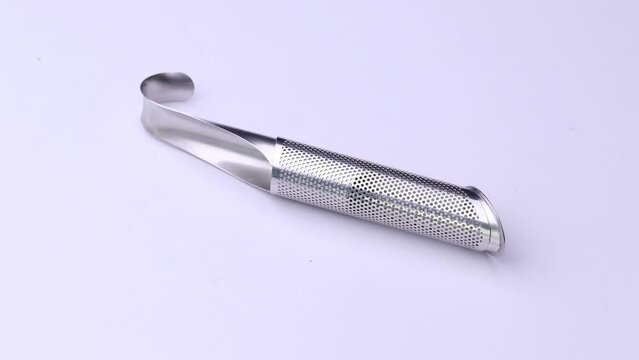 Tea infuser close-up on a white background, video of kitchen accessories.